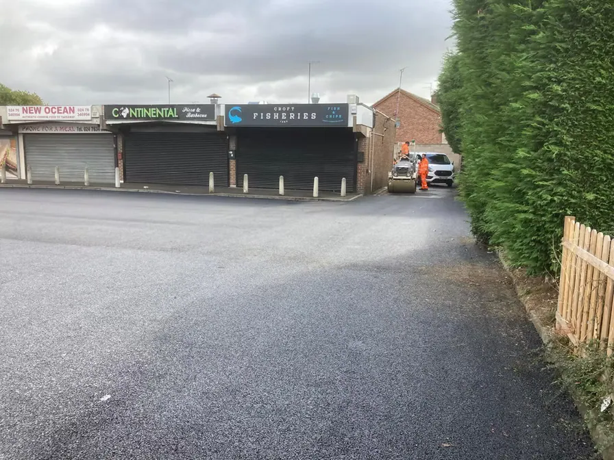 Resurfaced service road beside shops