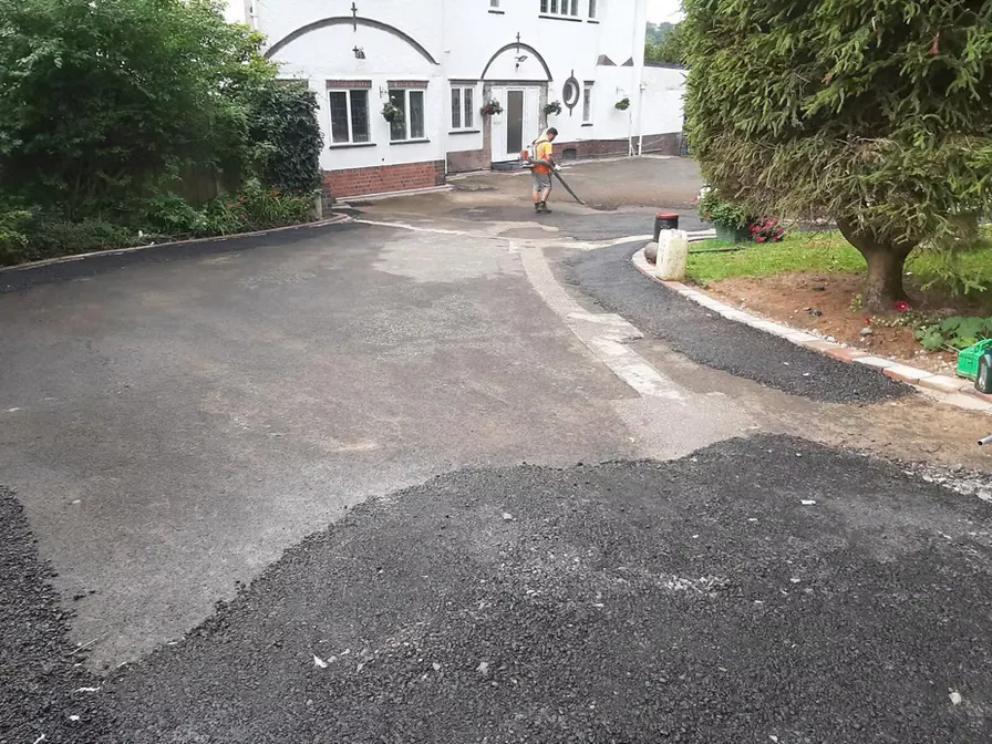 Tarmac yard outside a white building