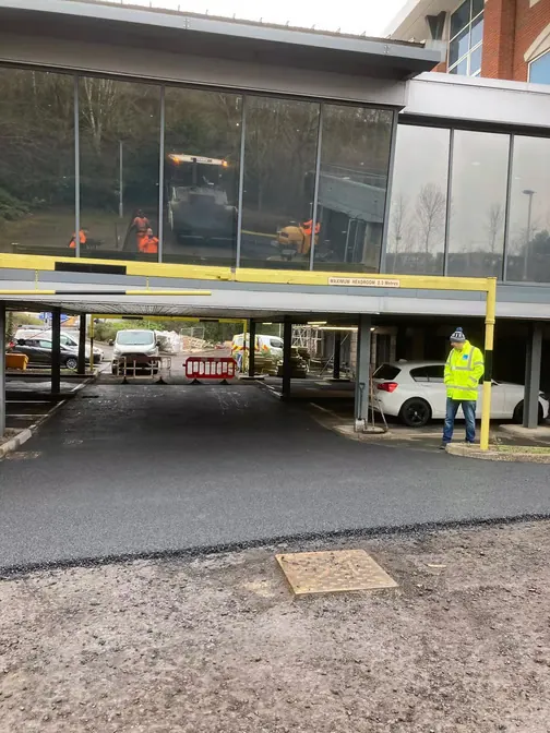 Surfacing under a building canopy
