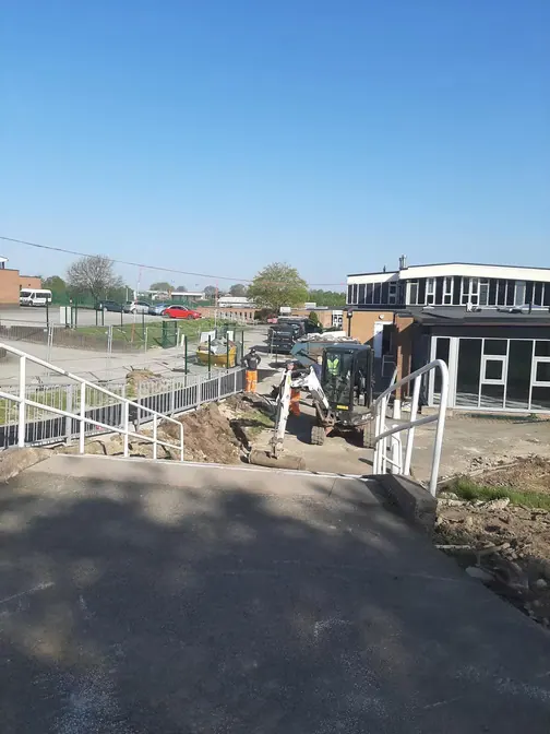 Path surfacing near a school fence